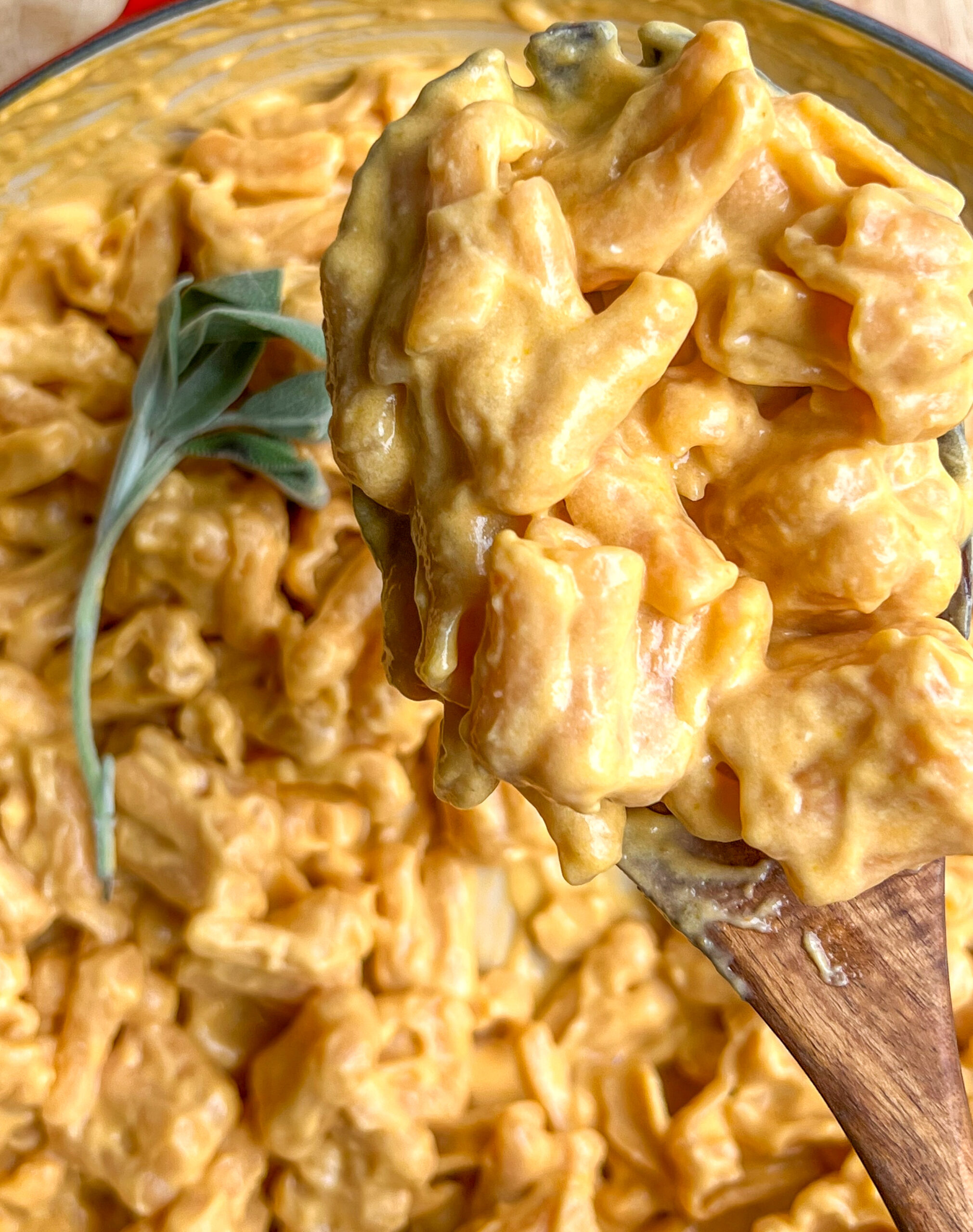 pumpkin mac and cheese on wooden spoon