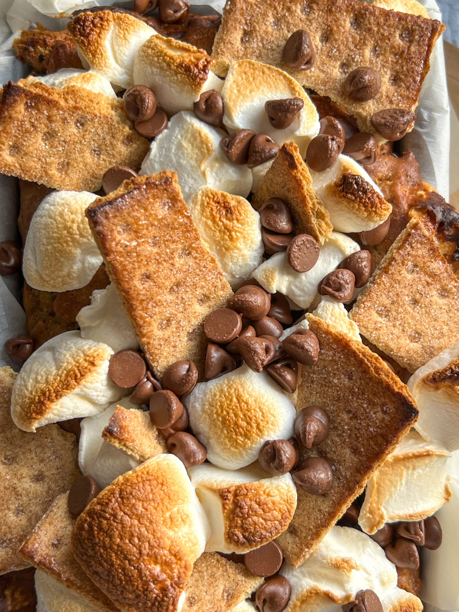 Decadent topping of graham crackers, marshmallows, and chocolate chips on S'mores Banana Bread