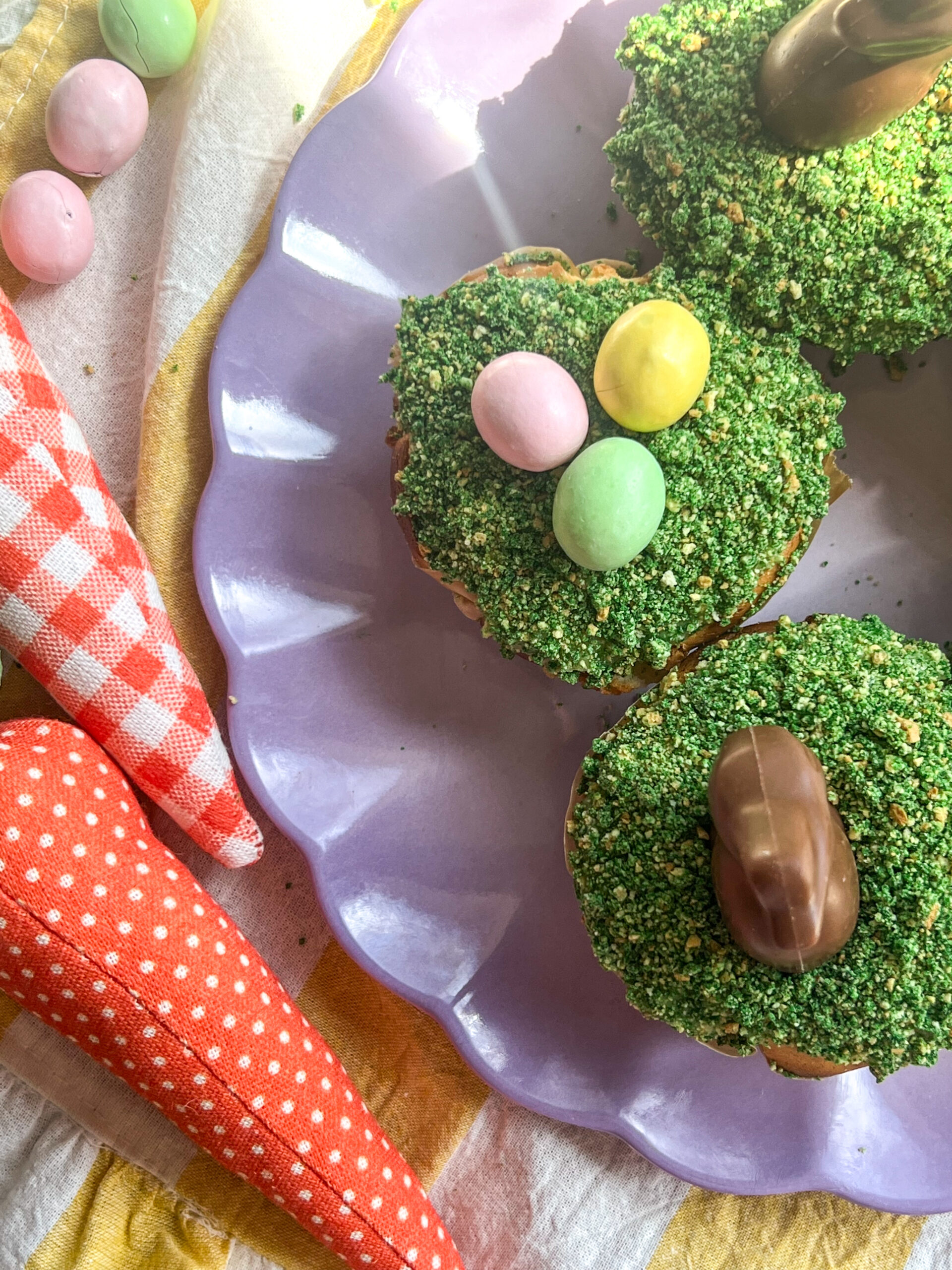 peter rabbit cheesecakes with robin egg and chocolate toppings on a scalloped plate