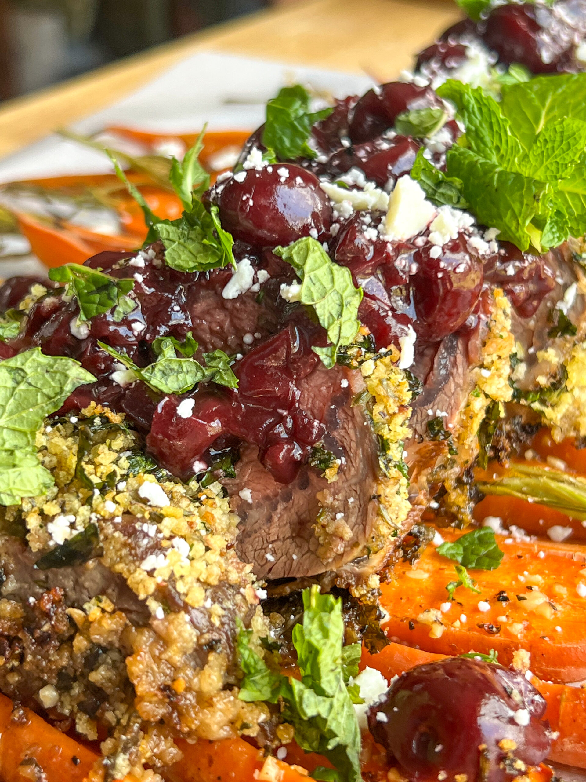 herb crusted rack of lamb with sweet cherry glaze topped with cherry glaze sauce