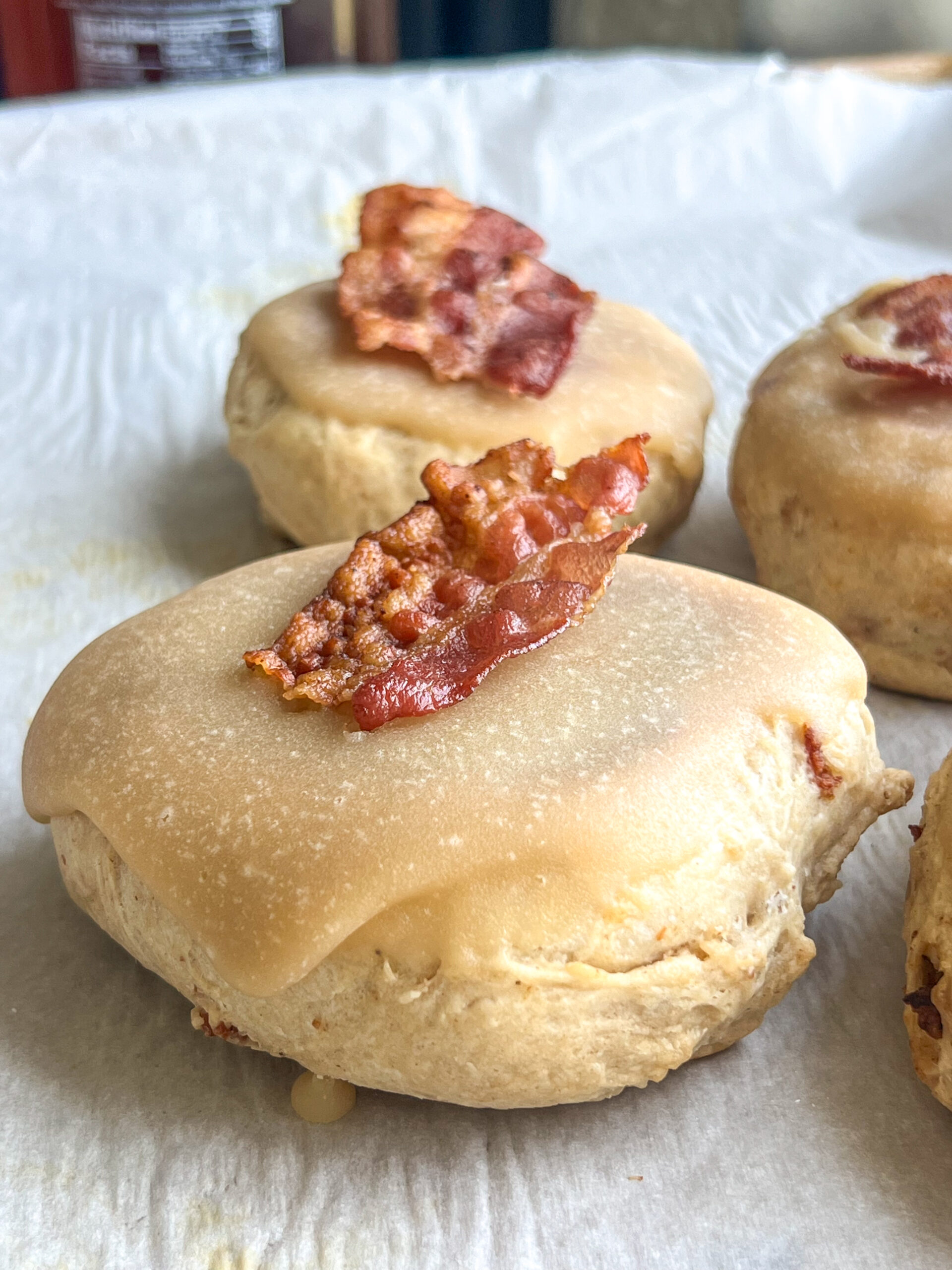 maple bacon donut english muffin with a slice of bacon on top