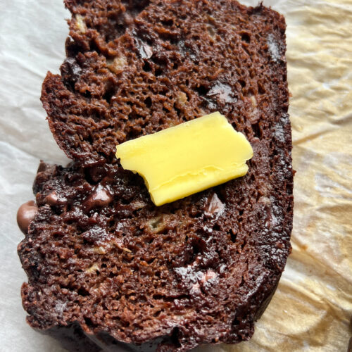 a slice of healthy brownie banana bread with butter
