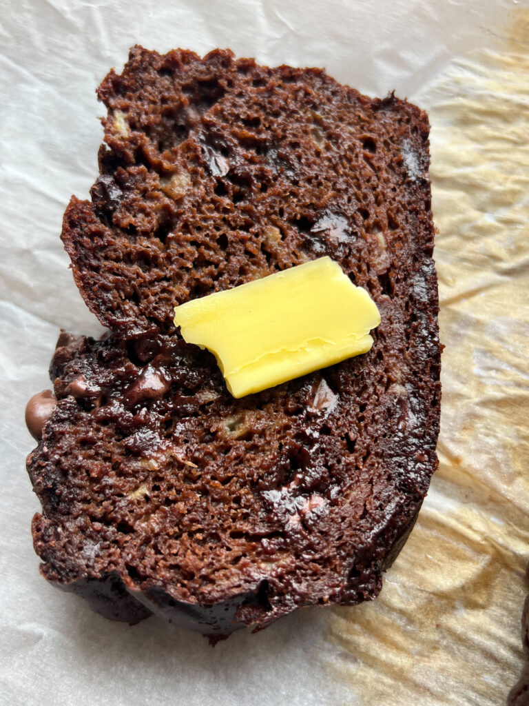 a slice of healthy brownie banana bread with butter