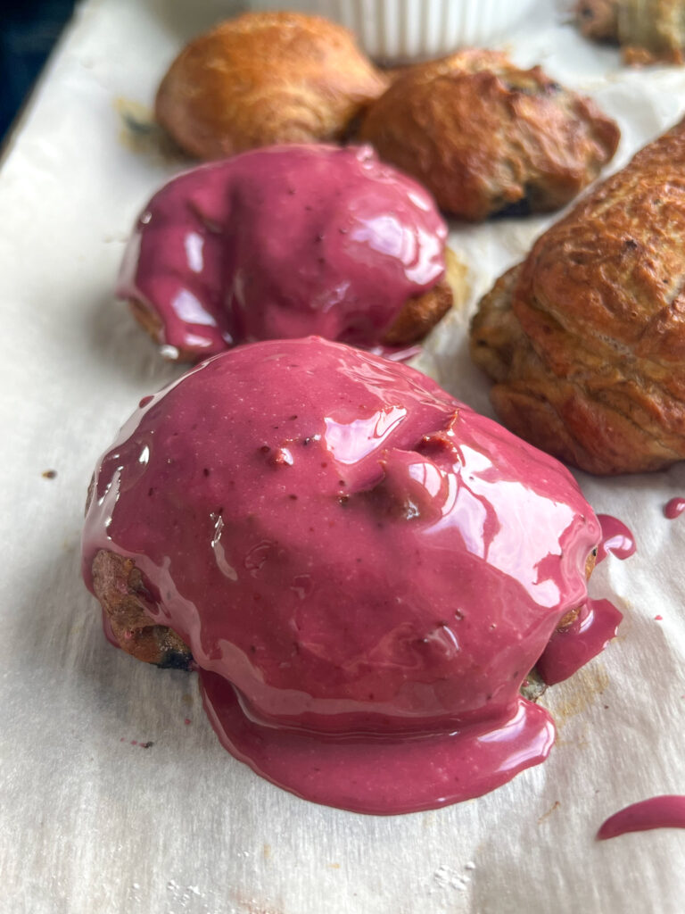 blueberry pretzel fritters with a shiny blueberry glaze