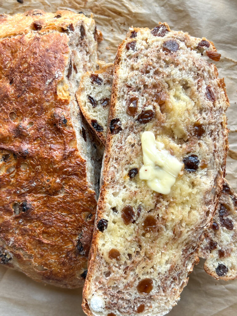 a slice of 2 hour artisan cinnamon raisin bread slathered in butter