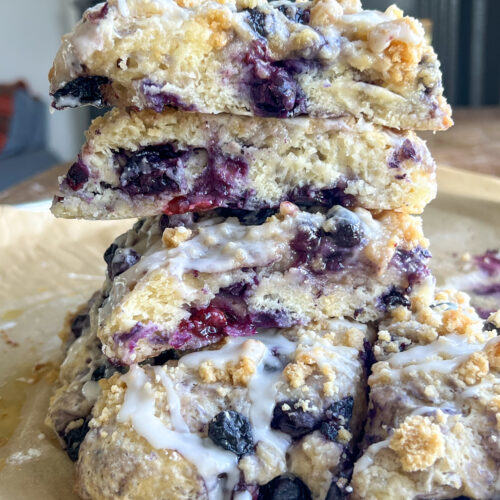 a stack of blueberry cobbler scones on parchment paper
