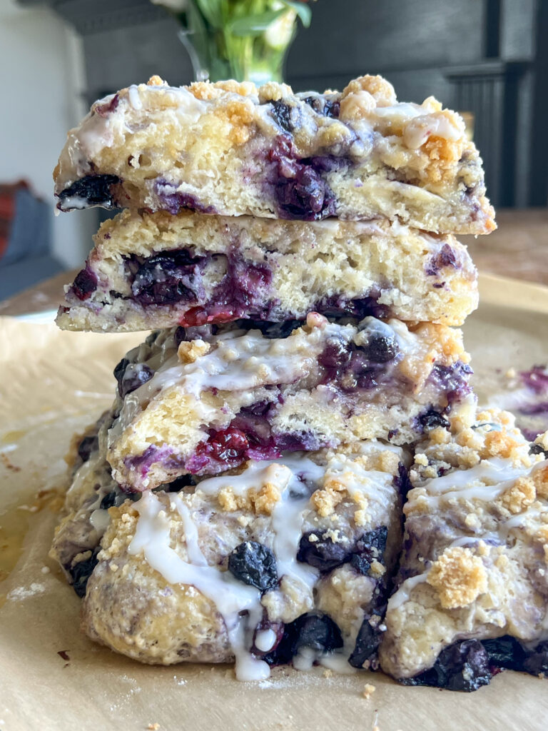 a stack of blueberry cobbler scones on parchment paper