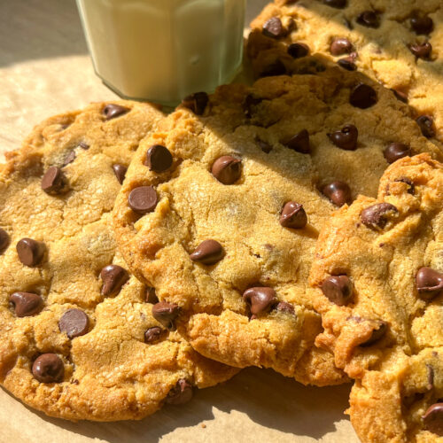 Chewy pumpkin chocolate chip cookies with a glass of milk