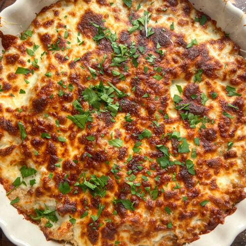 Savory French Onion Rice Pudding in cream ruffle pie dish