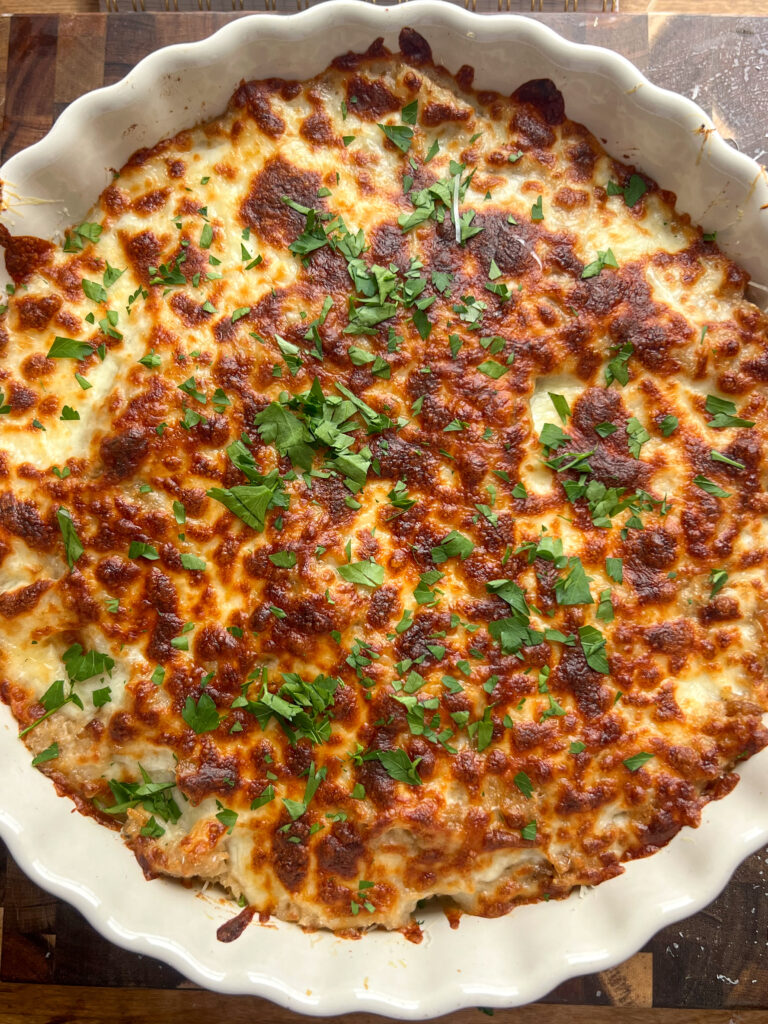 Savory French Onion Rice Pudding in cream ruffle pie dish