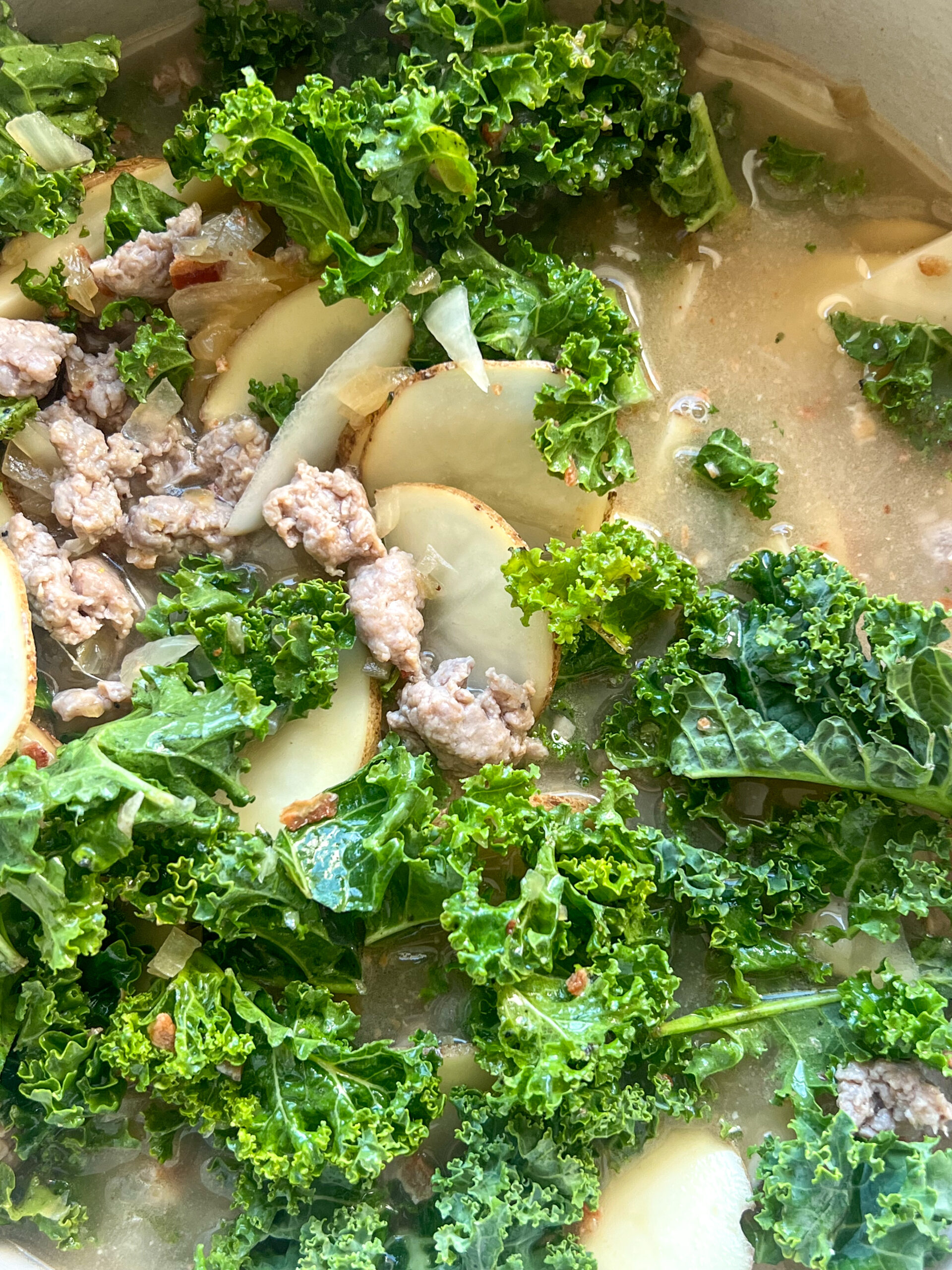 Zuppa Toscana in dutch oven with leafy greens